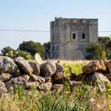 L�edificio, dalle mura massicce e compatte, si articola su due piani. In pietra tufacea di colore grigio, pare quasi una torre di avvistamento...